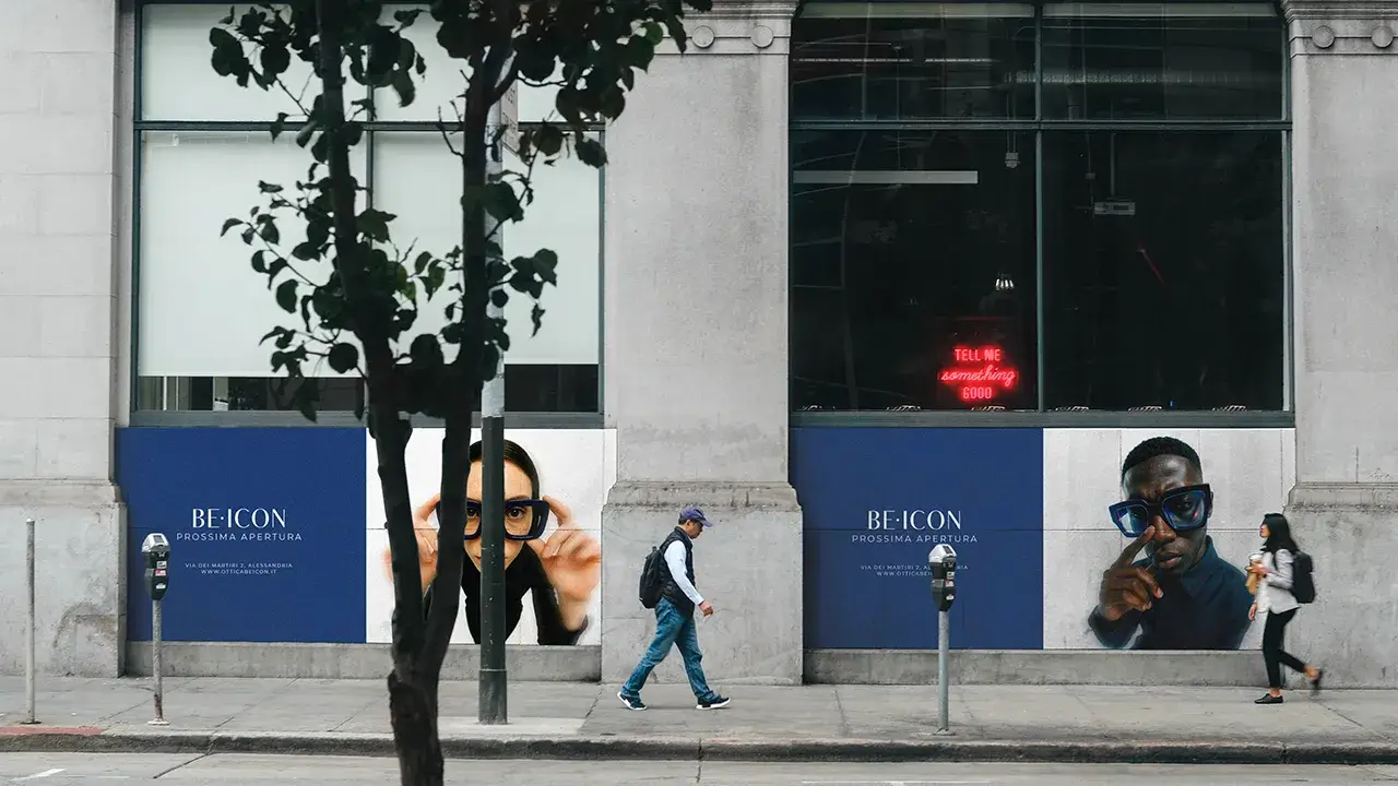 Advertisement BE•ICON with male and female model posing looking at the camera